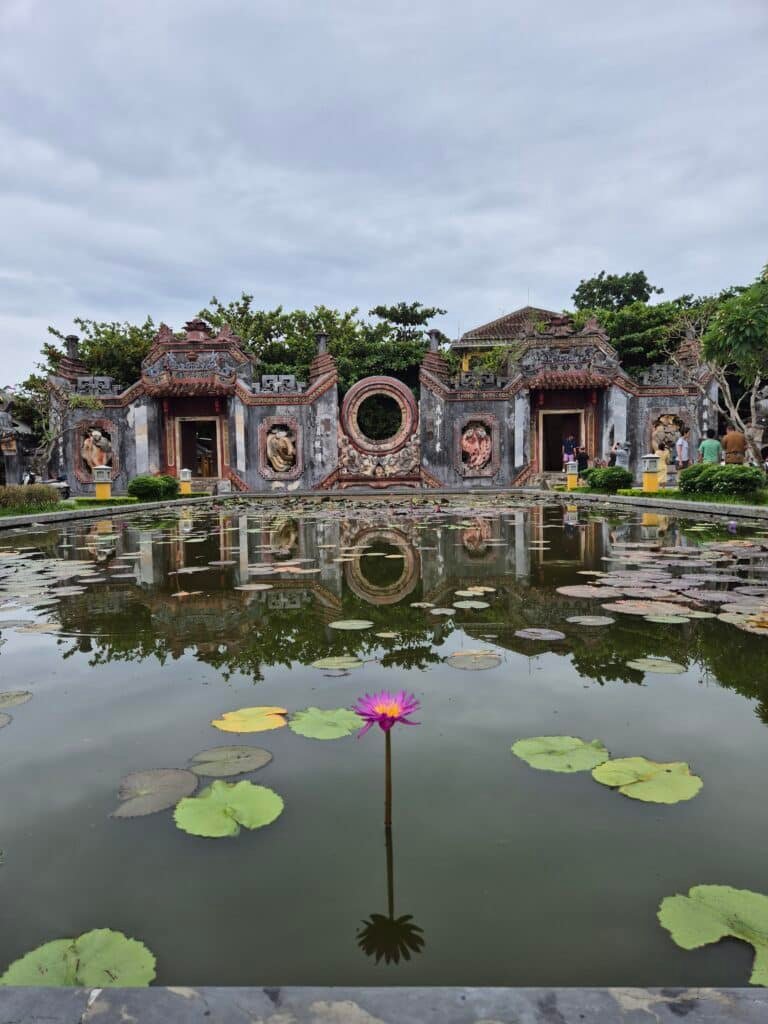 Porte du temple Ba Mu se reflétant dans un bassin de lotus à Hoi An